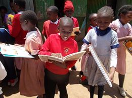 Kenyan child enjoying book from Books Abroad